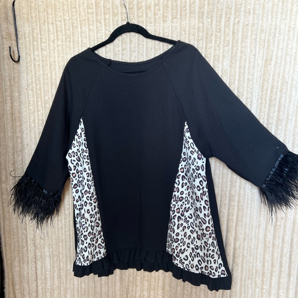 Black and White Leopard Print Women's Top with feathers on sleeve.